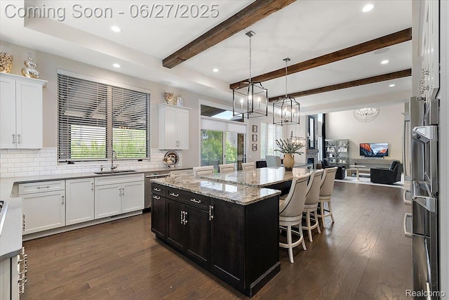 3610 Piccadilly Dr, Rochester Hills, MI 48309 - kitchen with a chandelier, a kitchen island, open floor plan, plenty of natural light, and beamed ceiling