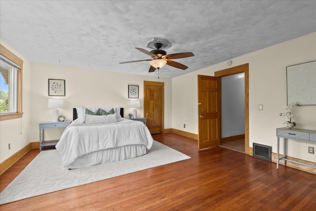 1122 Martin Luther King Jr St SE, Grand Rapids, MI 49507 - bedroom with wood finished floors, baseboards, a textured ceiling, and a ceiling fan