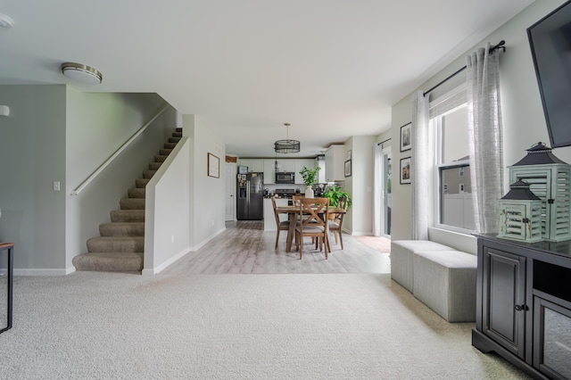 32822 Ravine St, New Haven, MI 48048 - dining room with stairs, baseboards, and light carpet