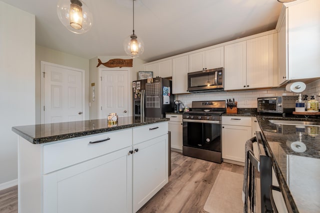 32822 Ravine St, New Haven, MI 48048 - kitchen featuring appliances with stainless steel finishes, light wood-type flooring, decorative backsplash, and white cabinets
