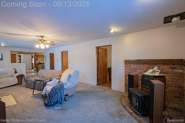 525 E Saint Clair St, Almont, MI 48003 - living area with carpet flooring, a wood stove, and a ceiling fan