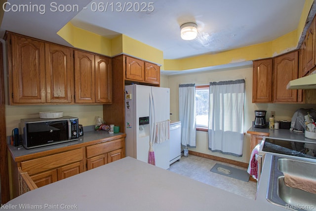 525 E Saint Clair St, Almont, MI 48003 - kitchen with white appliances, brown cabinetry, a sink, under cabinet range hood, and light floors