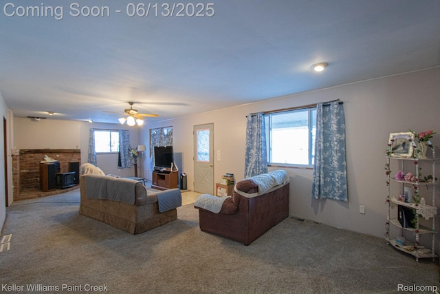 525 E Saint Clair St, Almont, MI 48003 - carpeted living room with a brick fireplace and a ceiling fan