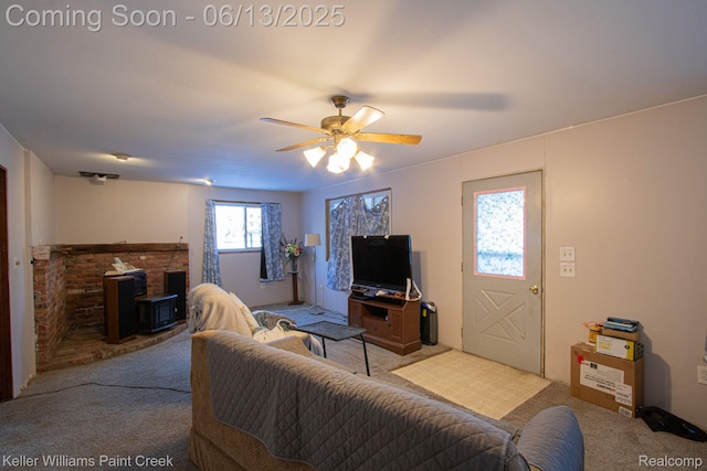 525 E Saint Clair St, Almont, MI 48003 - carpeted living room featuring a wood stove and ceiling fan