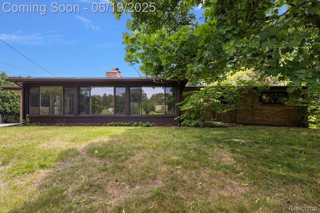 2732 Lone Pine Rd, West Bloomfield, MI 48323 - back of house featuring a chimney, a yard, and a sunroom
