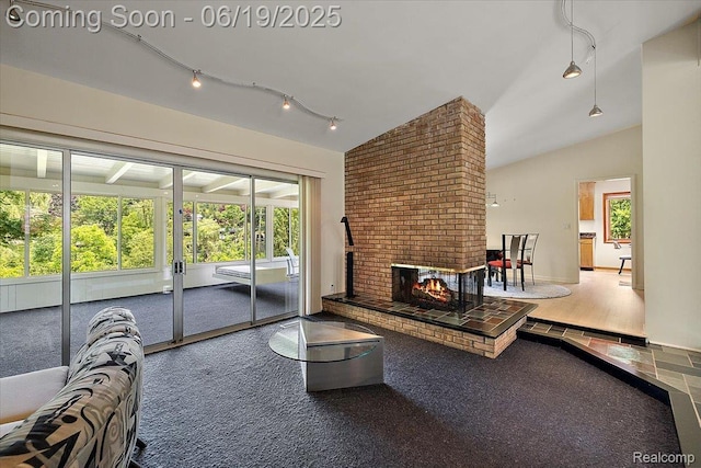 2732 Lone Pine Rd, West Bloomfield, MI 48323 - living area featuring rail lighting, lofted ceiling, plenty of natural light, and a brick fireplace