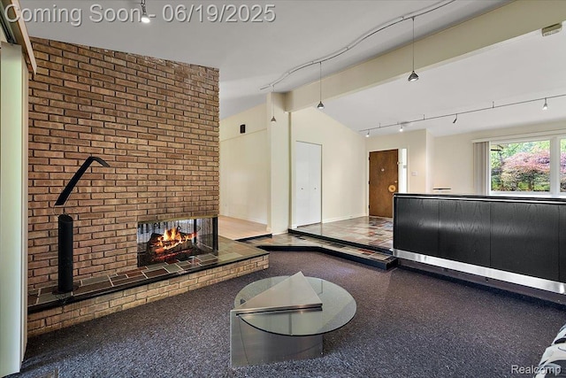 2732 Lone Pine Rd, West Bloomfield, MI 48323 - living room featuring rail lighting, lofted ceiling, a wood stove, and brick wall