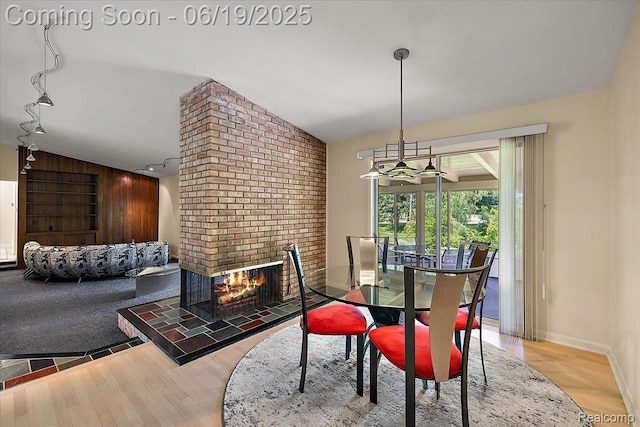 2732 Lone Pine Rd, West Bloomfield, MI 48323 - dining space featuring wood finished floors, a brick fireplace, and track lighting