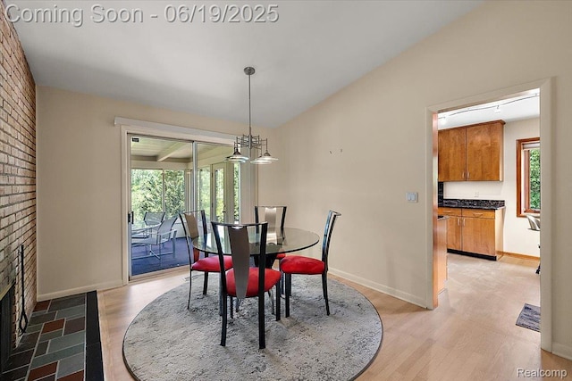 2732 Lone Pine Rd, West Bloomfield, MI 48323 - dining area featuring light wood finished floors, vaulted ceiling, and a brick fireplace