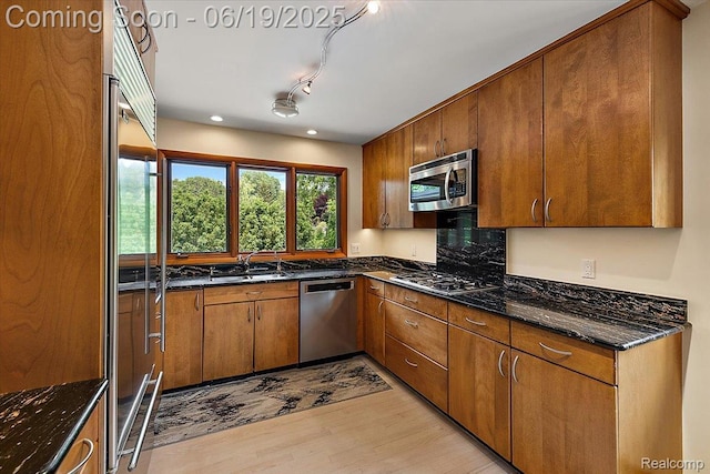 2732 Lone Pine Rd, West Bloomfield, MI 48323 - kitchen featuring appliances with stainless steel finishes, light wood-style flooring, brown cabinets, dark stone countertops, and recessed lighting
