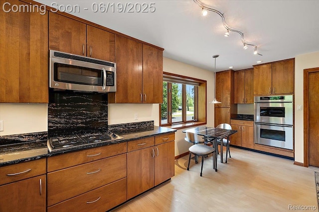 2732 Lone Pine Rd, West Bloomfield, MI 48323 - kitchen with appliances with stainless steel finishes, light wood finished floors, and brown cabinetry
