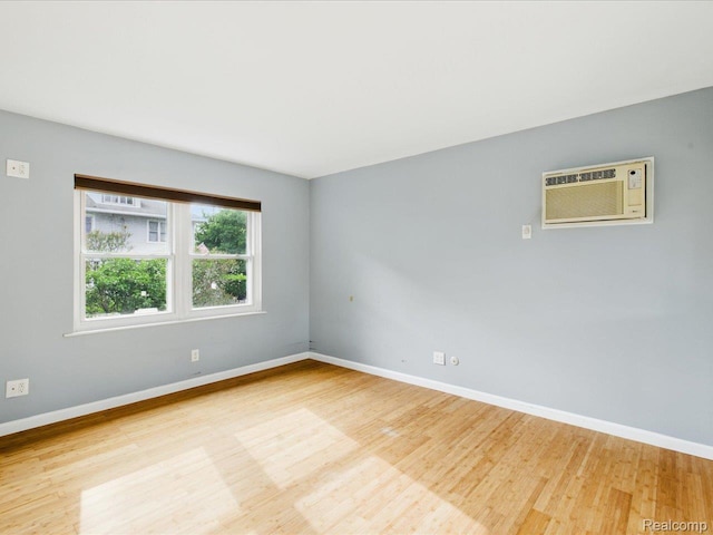 810 Holland Ave Unit 5, Port Huron, MI 48060 - empty room featuring wood finished floors and a wall mounted air conditioner