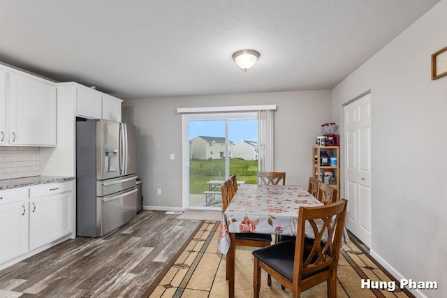 5764 Kiverton Ridge Dr SE, Grand Rapids, MI 49508 - dining area featuring baseboards and wood finished floors
