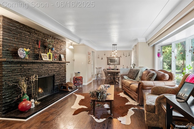 23385 Hunters Ln, Southfield, MI 48033 - living room with hardwood / wood-style floors, a stone fireplace, ornamental molding, and a chandelier