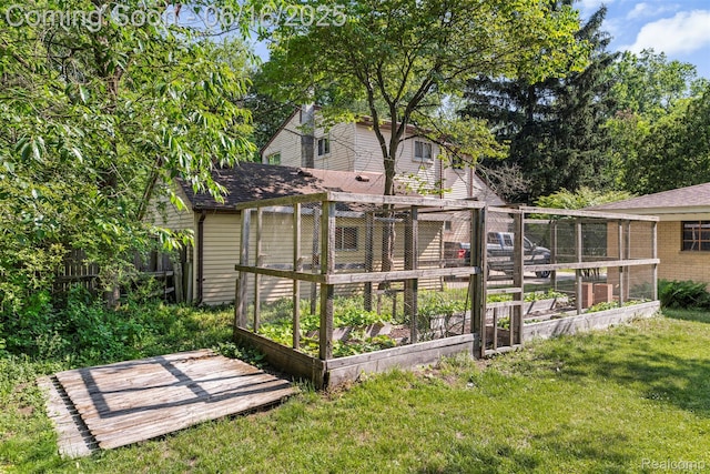 23385 Hunters Ln, Southfield, MI 48033 - back of house featuring a vegetable garden and a shingled roof