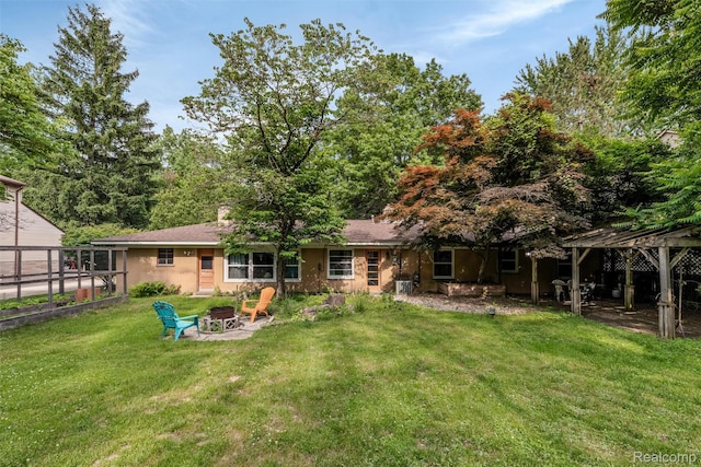 23385 Hunters Ln, Southfield, MI 48033 - rear view of property featuring a fire pit and a yard