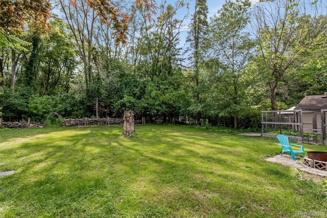 23385 Hunters Ln, Southfield, MI 48033 - view of grassy yard with a fire pit