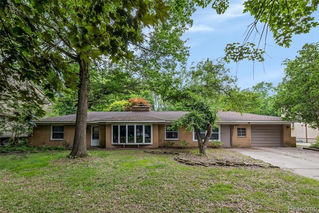 23385 Hunters Ln, Southfield, MI 48033 - ranch-style house with driveway, a garage, a front lawn, and brick siding