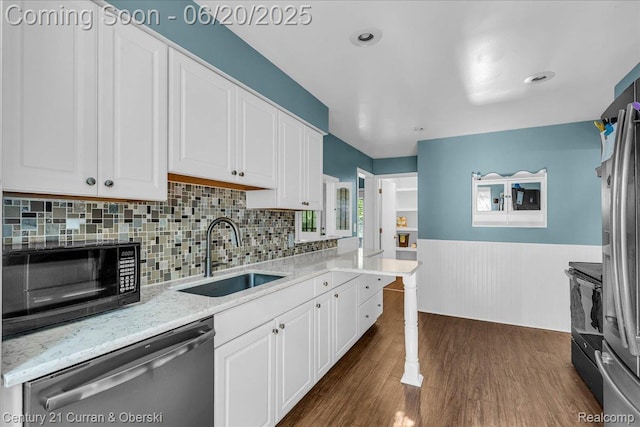 24121 Kraft Pl, Brownstown, MI 48174 - kitchen with stainless steel appliances, dark wood finished floors, white cabinetry, a wainscoted wall, and light stone countertops