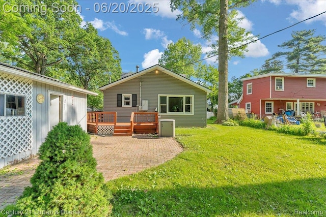 24121 Kraft Pl, Brownstown, MI 48174 - back of property with a deck, a yard, and a patio area