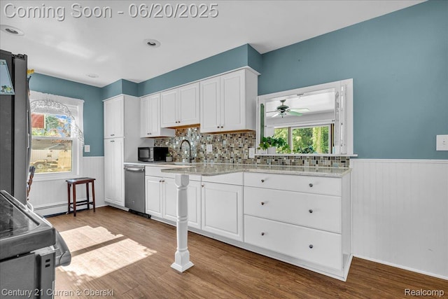 24121 Kraft Pl, Brownstown, MI 48174 - kitchen with wainscoting, dark wood-type flooring, white cabinets, a ceiling fan, and baseboard heating