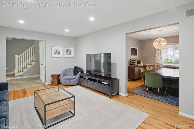 6821 Tamerlane Dr, West Bloomfield, MI 48322 - living area featuring stairs, wood finished floors, a chandelier, and recessed lighting