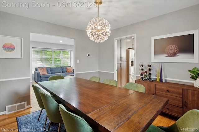 6821 Tamerlane Dr, West Bloomfield, MI 48322 - dining space with a chandelier and wood finished floors