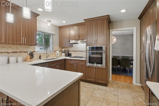 6821 Tamerlane Dr, West Bloomfield, MI 48322 - kitchen featuring stainless steel appliances, under cabinet range hood, tasteful backsplash, light countertops, and recessed lighting