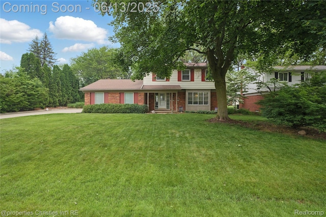 6821 Tamerlane Dr, West Bloomfield, MI 48322 - traditional home featuring brick siding, a front yard, driveway, and an attached garage