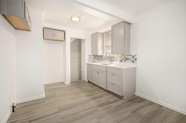 16086 Carlisle St, Detroit, MI 48205 - bathroom featuring wood finished floors, tasteful backsplash, vanity, and baseboards