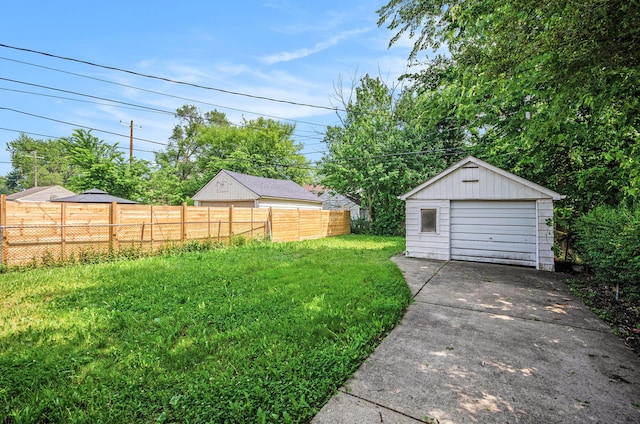 16086 Carlisle St, Detroit, MI 48205 - view of yard featuring a garage, concrete driveway, and an outbuilding