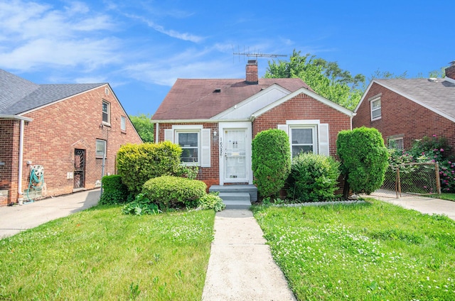 16086 Carlisle St, Detroit, MI 48205 - bungalow-style house featuring brick siding, a chimney, and a shingled roof