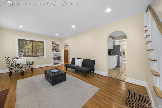 1630 W Houstonia Ave, Royal Oak, MI 48073 - living area featuring arched walkways, light wood-style flooring, baseboards, recessed lighting, and stairs