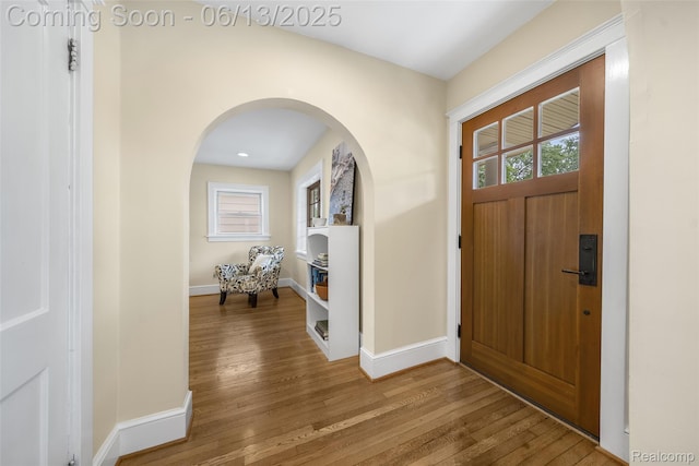 1630 W Houstonia Ave, Royal Oak, MI 48073 - foyer entrance with arched walkways, wood finished floors, and baseboards