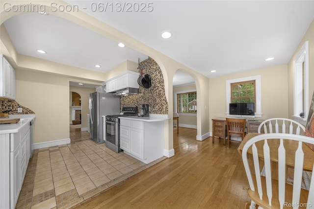 1630 W Houstonia Ave, Royal Oak, MI 48073 - kitchen with gas range oven, arched walkways, decorative backsplash, white cabinetry, and recessed lighting