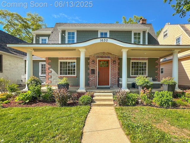 1630 W Houstonia Ave, Royal Oak, MI 48073 - view of front of home featuring a porch, a chimney, and brick siding
