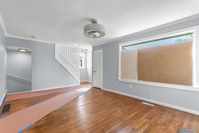 16558 Indiana St, Detroit, MI 48221 - empty room featuring crown molding, stairs, baseboards, and wood finished floors