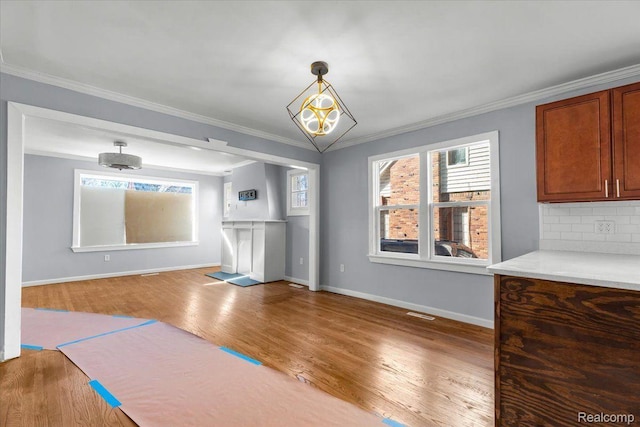16558 Indiana St, Detroit, MI 48221 - unfurnished dining area with ornamental molding, wood finished floors, and baseboards