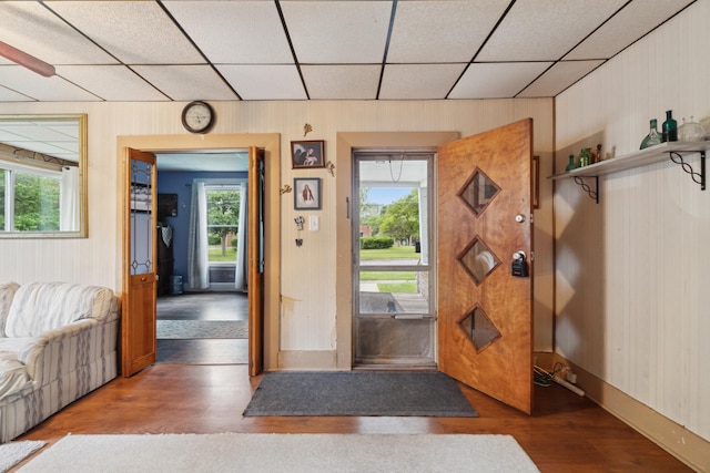 1704 Pringle Ave, Jackson, MI 49203 - foyer entrance with wood finished floors, plenty of natural light, wood walls, and a paneled ceiling