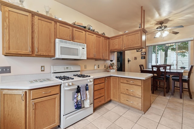 1704 Pringle Ave, Jackson, MI 49203 - kitchen featuring white appliances, light tile patterned floors, light countertops, a peninsula, and a ceiling fan
