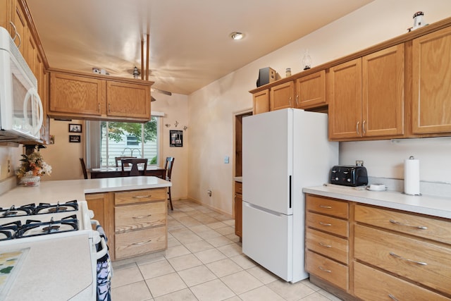 1704 Pringle Ave, Jackson, MI 49203 - kitchen with white appliances, light countertops, light tile patterned floors, and brown cabinets