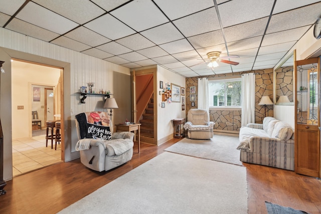 1704 Pringle Ave, Jackson, MI 49203 - living room with stairway, wood finished floors, a paneled ceiling, and ceiling fan