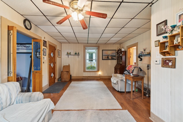 1704 Pringle Ave, Jackson, MI 49203 - living room with wood finished floors, a paneled ceiling, ceiling fan, and baseboards