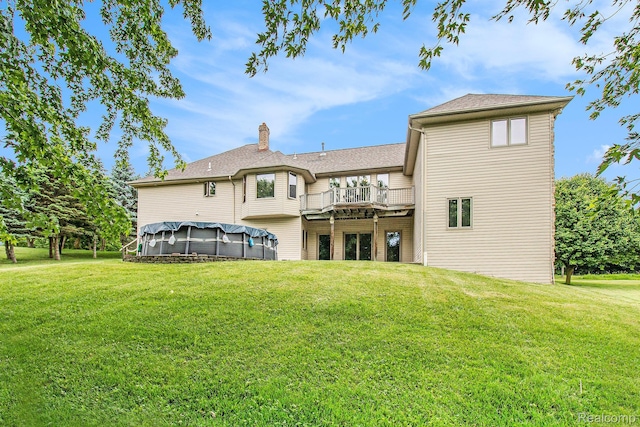 6443 Baldwin Rd, Swartz Creek, MI 48473 - rear view of house with a lawn and a chimney