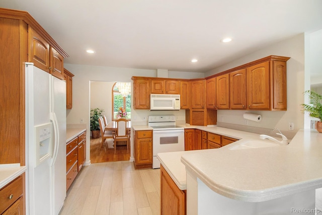 6443 Baldwin Rd, Swartz Creek, MI 48473 - kitchen with white appliances, light wood-style floors, a peninsula, light countertops, and recessed lighting