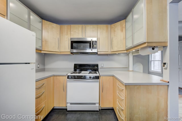 263 E Woodland St, Ferndale, MI 48220 - kitchen with white appliances, light brown cabinetry, light countertops, dark wood-style flooring, and glass insert cabinets