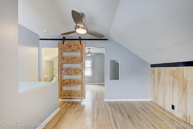 263 E Woodland St, Ferndale, MI 48220 - unfurnished living room featuring a ceiling fan, wood finished floors, vaulted ceiling, and a barn door