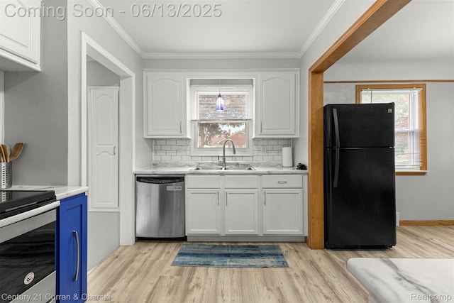 8904 Becker Ave, Allen Park, MI 48101 - kitchen featuring appliances with stainless steel finishes, white cabinetry, light wood finished floors, decorative backsplash, and ornamental molding