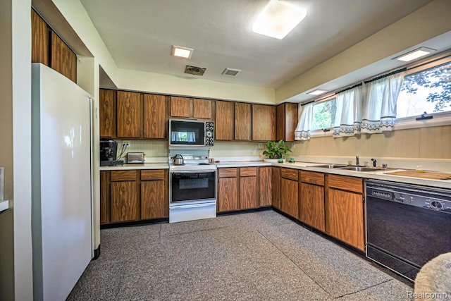 23880 Glencreek Dr, Farmington Hills, MI 48336 - kitchen with black appliances, light countertops, and brown cabinets