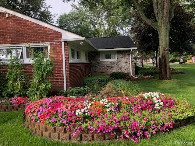 23880 Glencreek Dr, Farmington Hills, MI 48336 - view of home's exterior featuring brick siding and a lawn